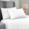 A neatly made bed featuring a white 1000 Thread Count Cotton Blend Sheets Set with a solid deep pocket, showcasing crisp white pillows and smooth flat and fitted sheets