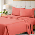 A neatly made bed styled with a coral 700 Thread Count Egyptian Cotton Sateen Bed Sheet Set, featuring smooth flat and fitted sheets alongside matching pillows
