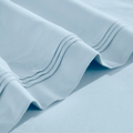 Close-up of Baby blue Egyptian cotton sateen sheet hems with decorative triple-row stitching.
