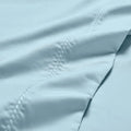Blue Imperia embroidered hem pillowcase set close-up detail.
