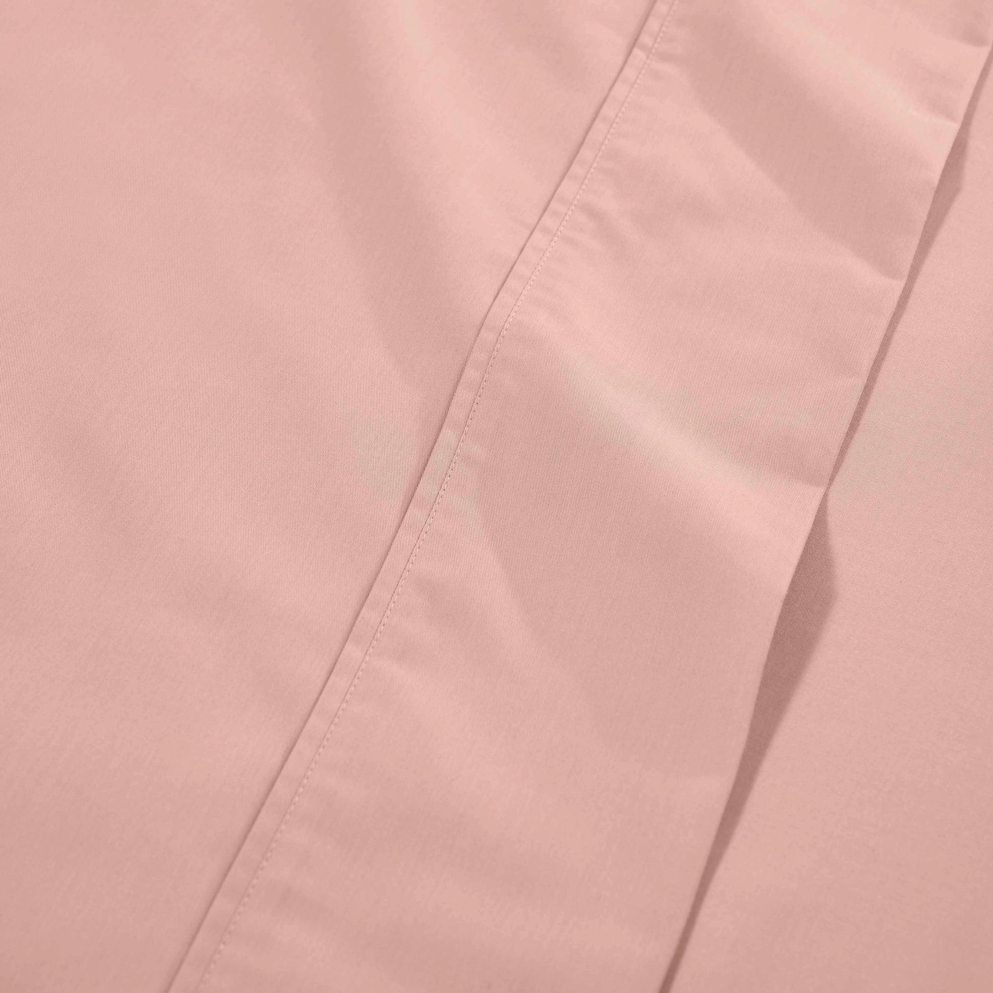Blush pink 1000 Thread Count Cotton Blend Sheets Set solid deep pocket hemline and stitching close-up fabric texture