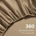Close-up of a taupe fitted sheet with elastic gathering, featuring the text 