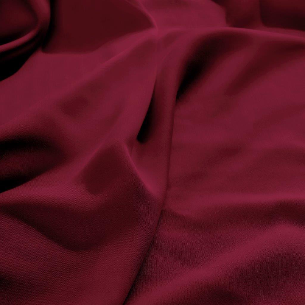 Close-up texture view of smooth, draped burgundy 300 thread count modal sheets made from beechwood