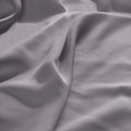 Close-up texture view of smooth, draped grey 300 thread count modal sheets made from beechwood