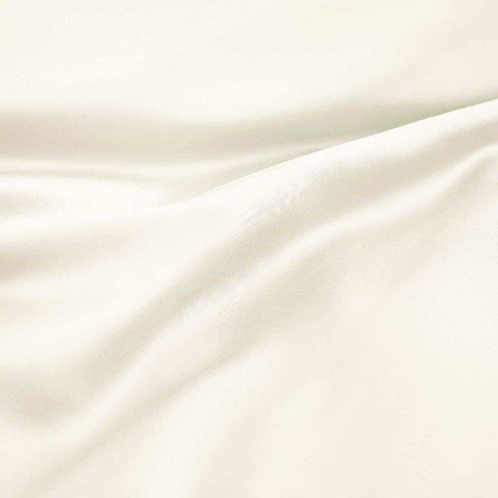 Close-up texture view of smooth, draped ivory 300 thread count modal sheets made from beechwood