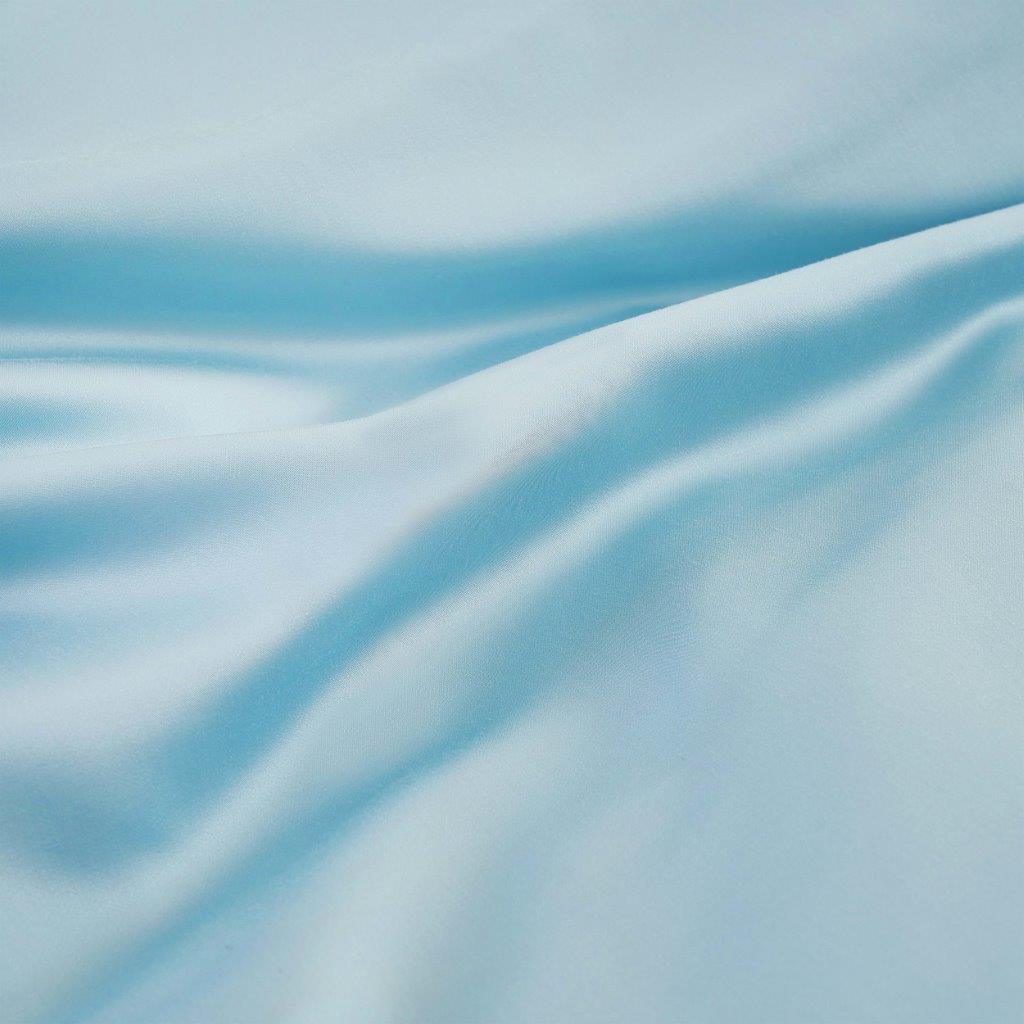 Close-up texture view of smooth, draped light blue 300 thread count modal sheets made from beechwood