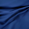 Close-up texture view of smooth, draped navy blue 300 thread count modal sheets made from beechwood