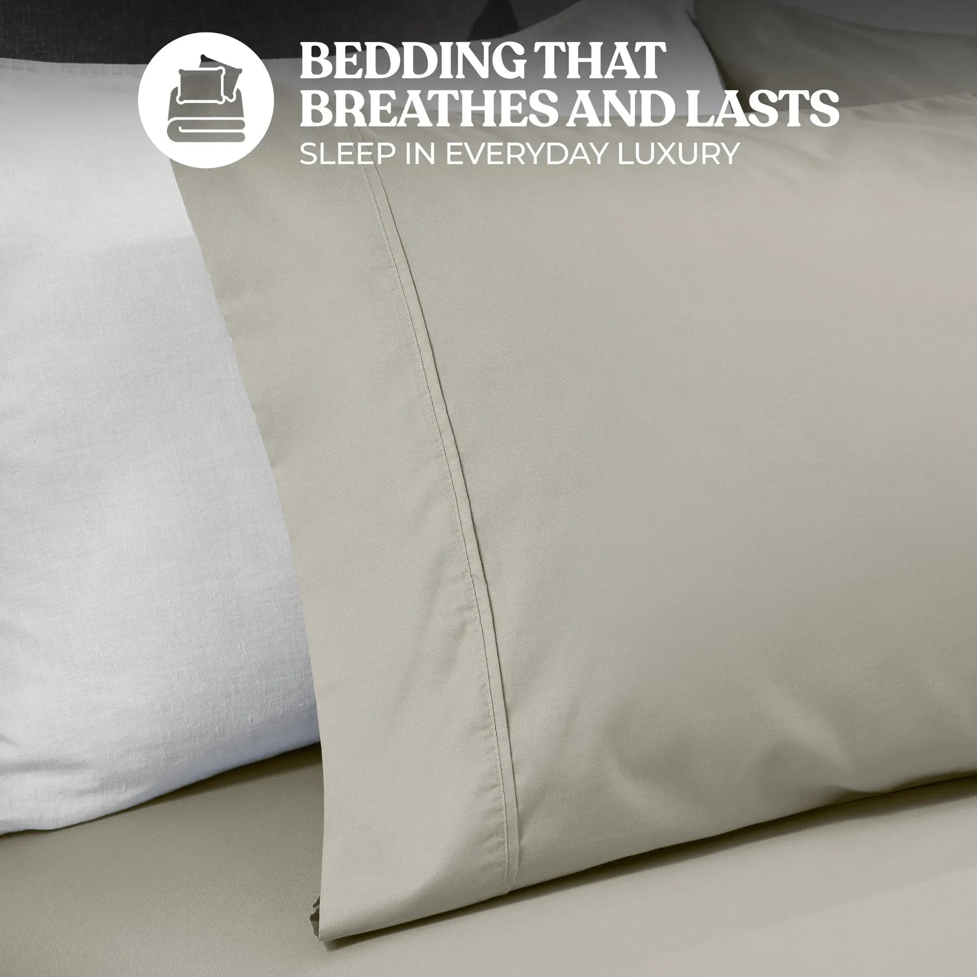 Close-up view of a stone gray cotton blend pillowcase showing stitched hem detailing and fabric texture