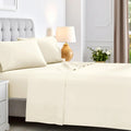 Cream colored 600 thread count cotton blend bed sheet set on a neatly made bed