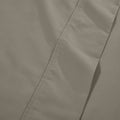 Extreme close-up macro shot of dark grey cotton blend fabric showing fine weave texture and subtle hem stitching
