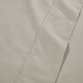 Extreme close-up macro shot of stone gray cotton blend fabric showing fine weave texture and subtle hem stitching