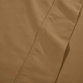 Extreme close-up macro shot of taupe brown cotton blend fabric showing fine weave texture and subtle hem stitching
