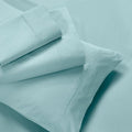 Folded light blue flat sheet, fitted sheet, and pillowcases showing stitched hem borders