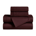 Folded plum 650 thread count Egyptian cotton sateen sheet set with sheets and matching pillowcases.
