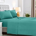 Full bedroom view of a teal deep pocket sheet set featuring matching pillowcases and flat sheet
