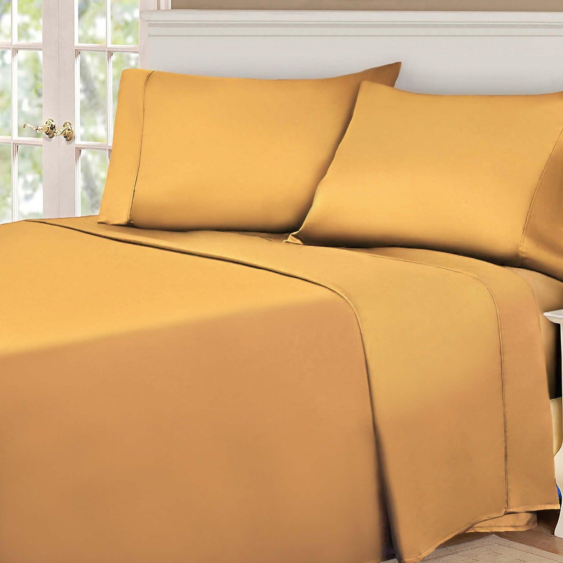 Gold Yellow 530 Thread Count Egyptian Cotton Sateen Bed Sheet Set displayed on a modern bed