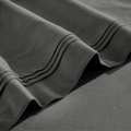 Close-up of gray Egyptian cotton sateen sheet hems with decorative triple-row stitching.