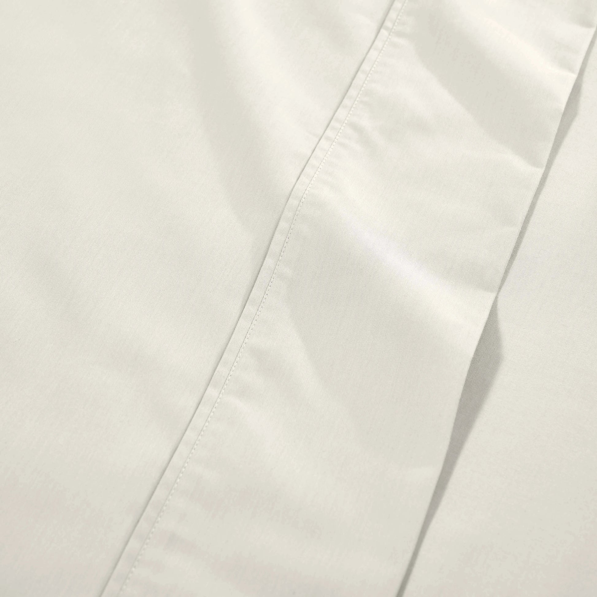 Ivory 1000 Thread Count Cotton Blend Sheets Set solid deep pocket hemline and stitching close-up fabric texture