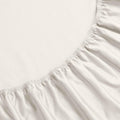 Ivory 1500 Thread Count Egyptian Cotton Fitted Sheet corner elastic band close-up texture.