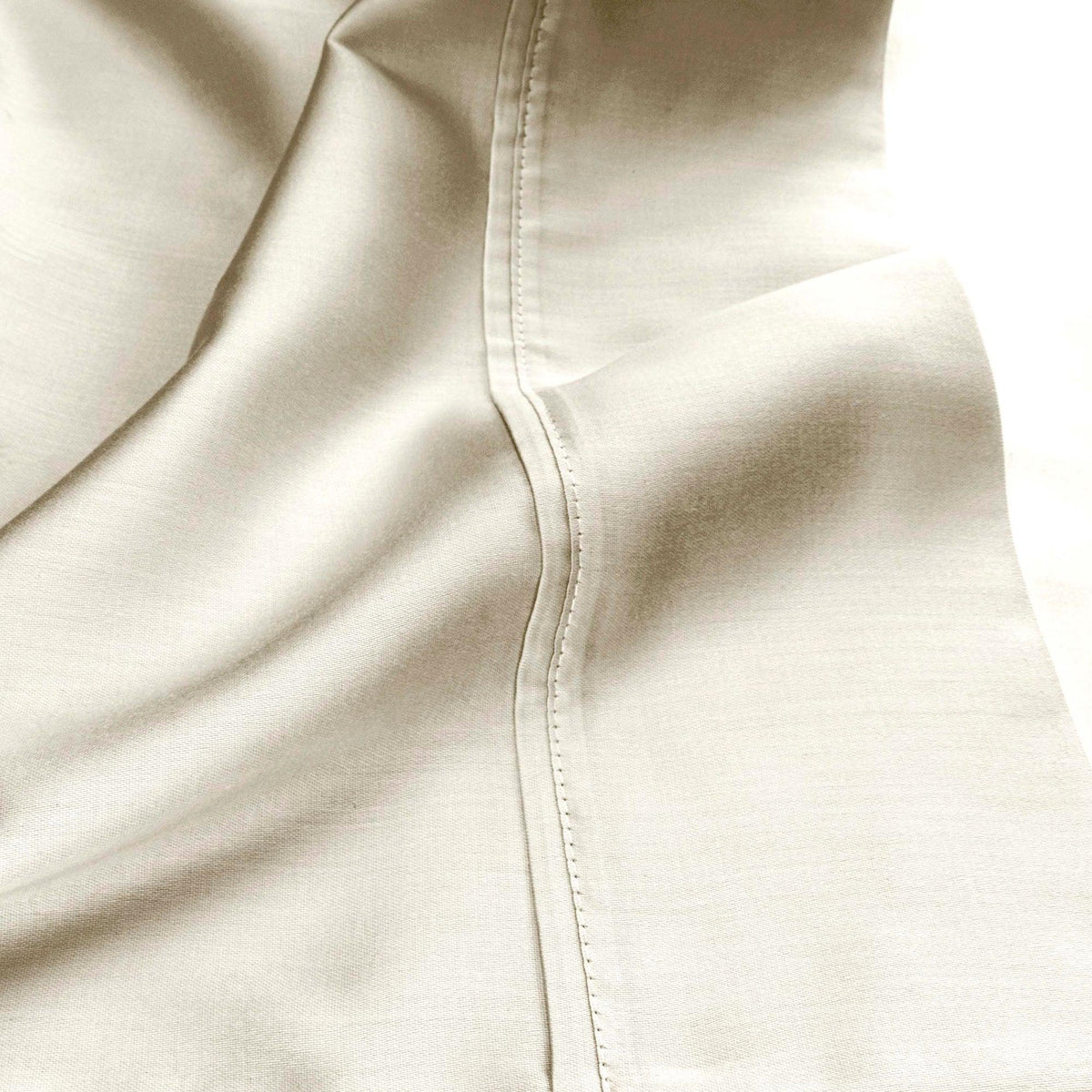 Ivory 530 Thread Count Egyptian Cotton Sateen sheet hem and stitching detail close-up