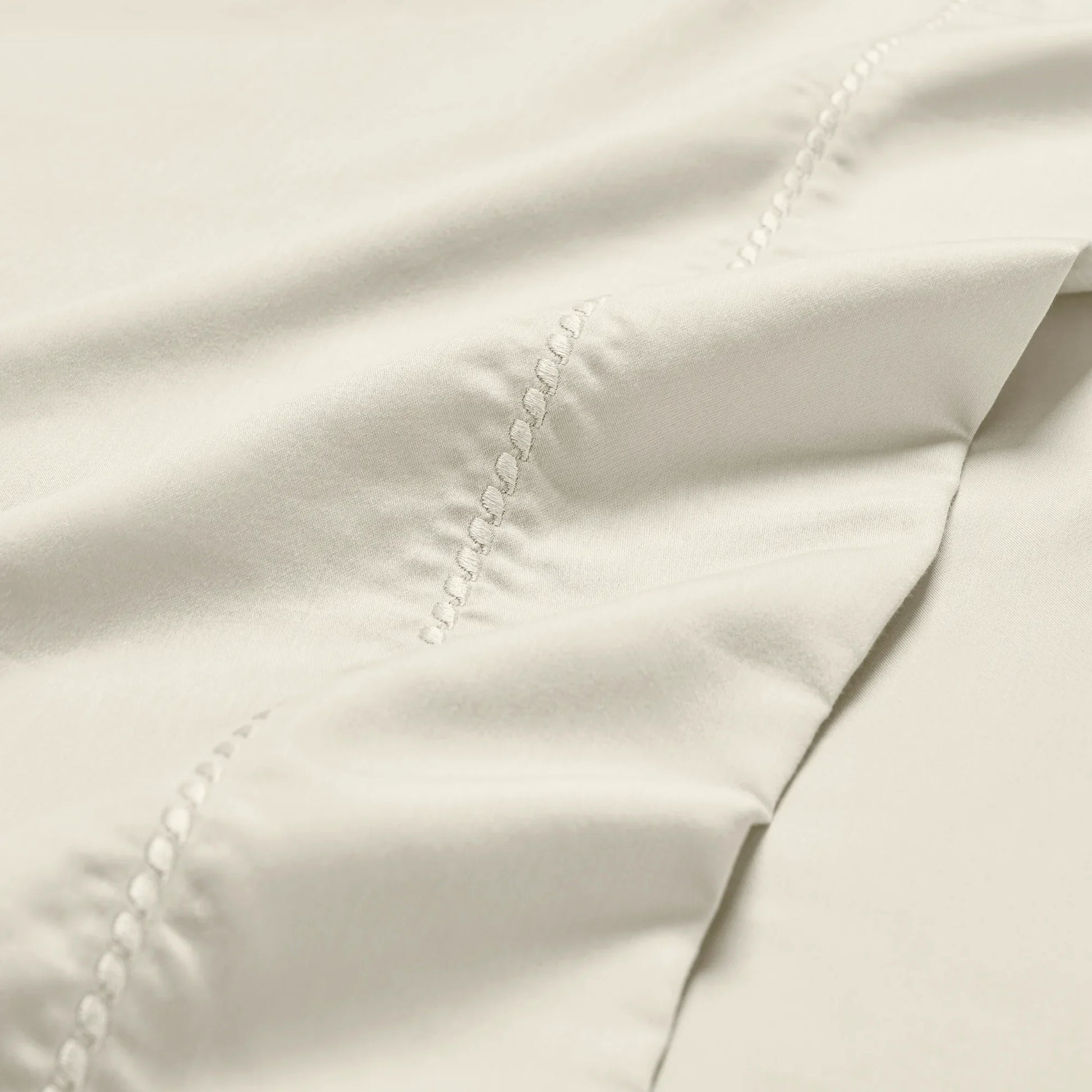 Ivory 600 Thread Count Cotton Blend Bed Sheet Set Imperia embroidery detail close-up texture.