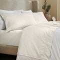 Ivory 600 Thread Count Cotton Blend Bed Sheet Set with Imperia embroidered hem details on a luxury lifestyle bed display.