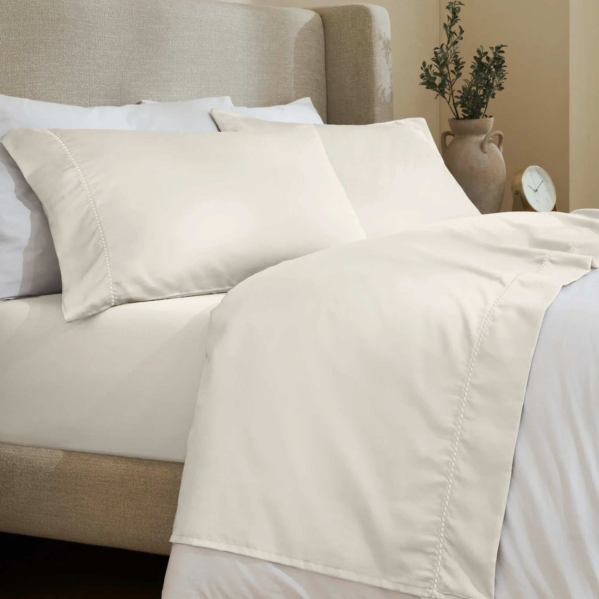 Ivory 600 Thread Count Cotton Blend Bed Sheet Set with Imperia embroidered hem details on a luxury lifestyle bed display.