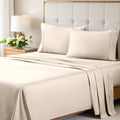 Ivory 700 Thread Count Egyptian Cotton Sateen Bed Sheet Set displayed on a modern bed