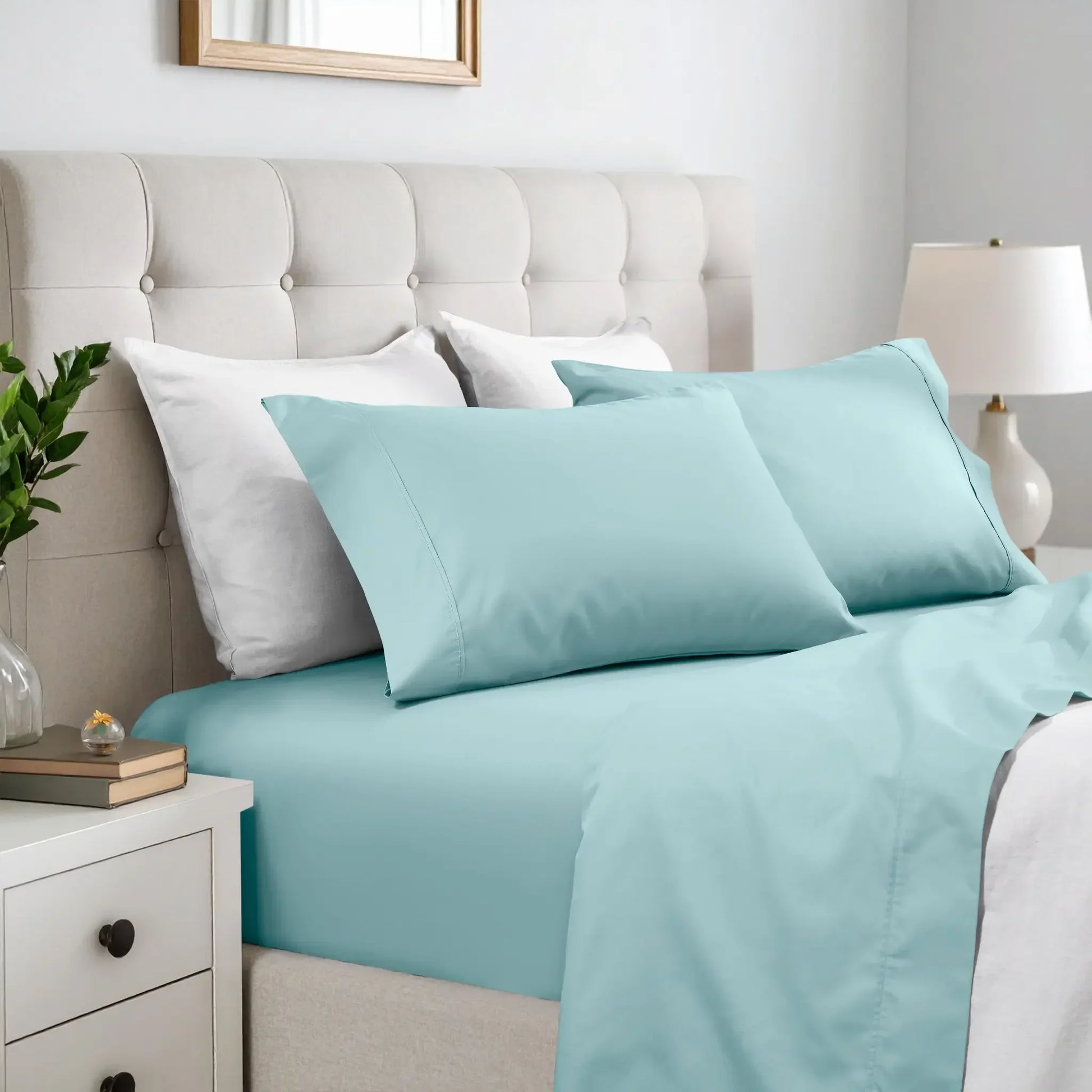 Light blue 600 thread count cotton blend bed sheet set on a neatly made bed