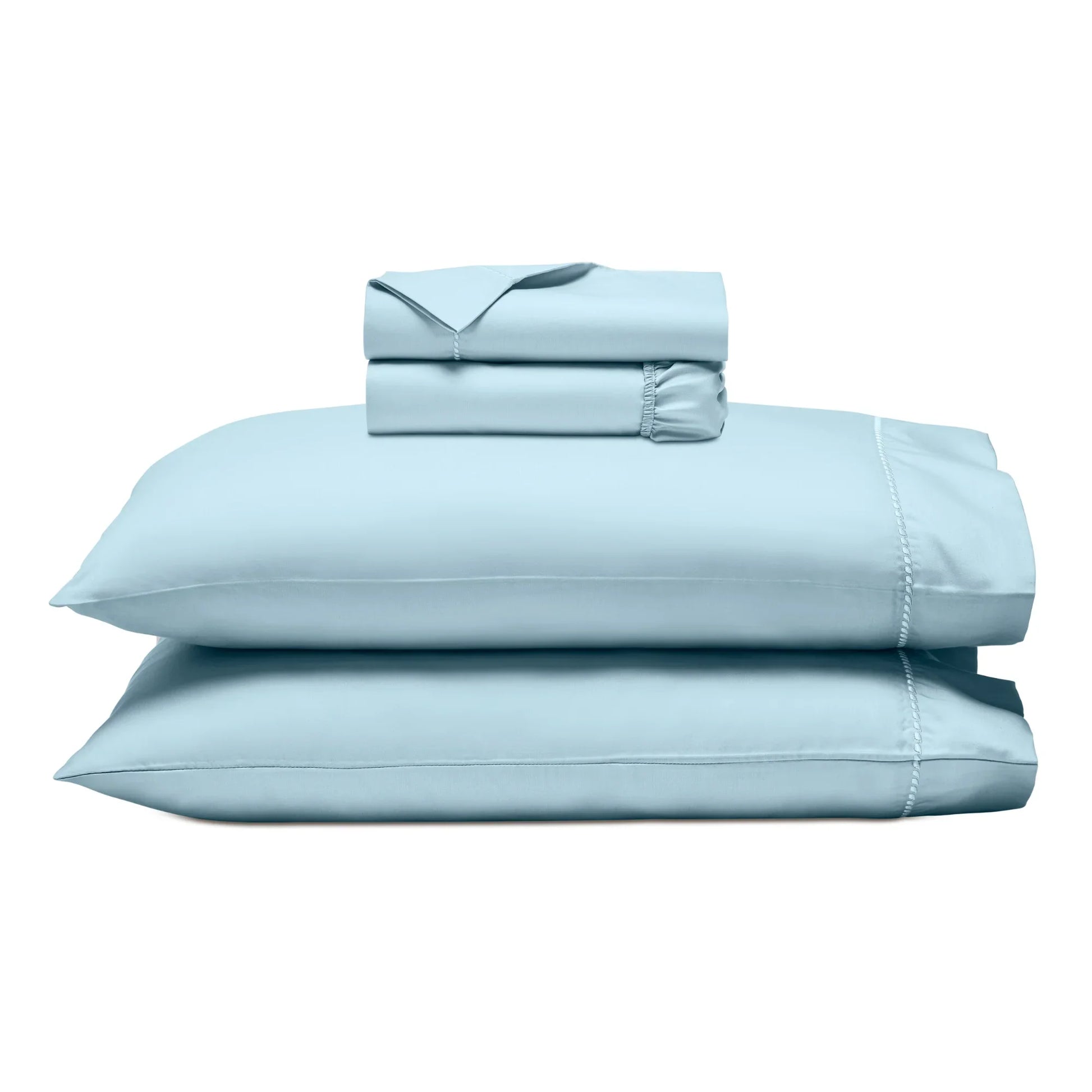 Light blue bed sheets and pillowcases set on a white background