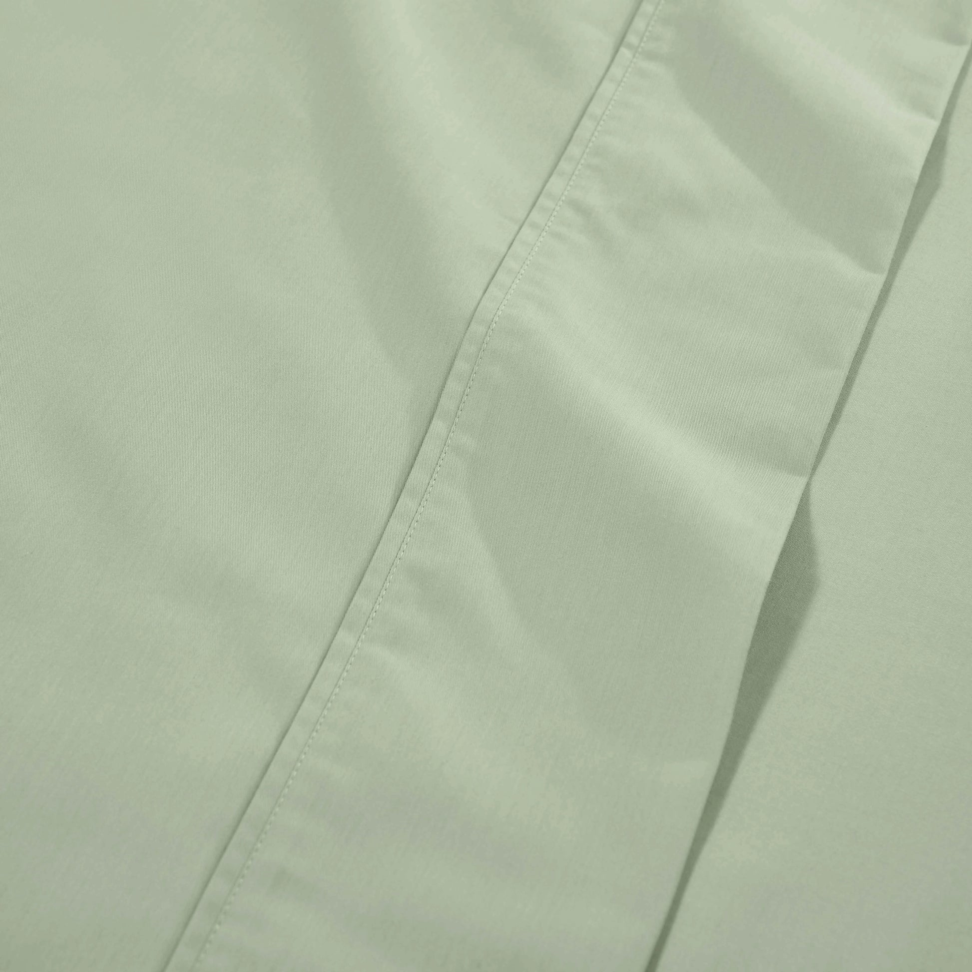 Light green 1000 Thread Count Cotton Blend Sheets Set solid deep pocket hemline and stitching close-up fabric texture