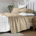 Linen 650 thread count Egyptian cotton sateen sheets arranged on a modern bed with coordinating pillows.