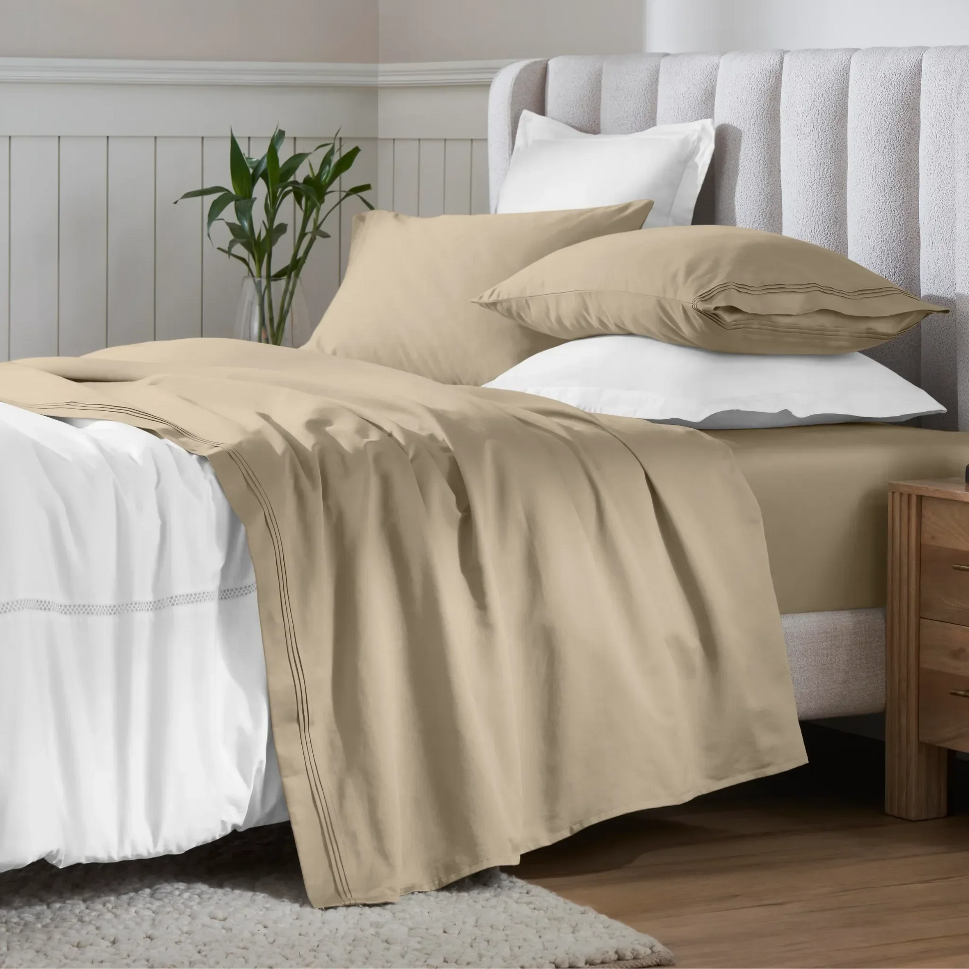 Linen 650 thread count Egyptian cotton sateen sheets arranged on a modern bed with coordinating pillows.