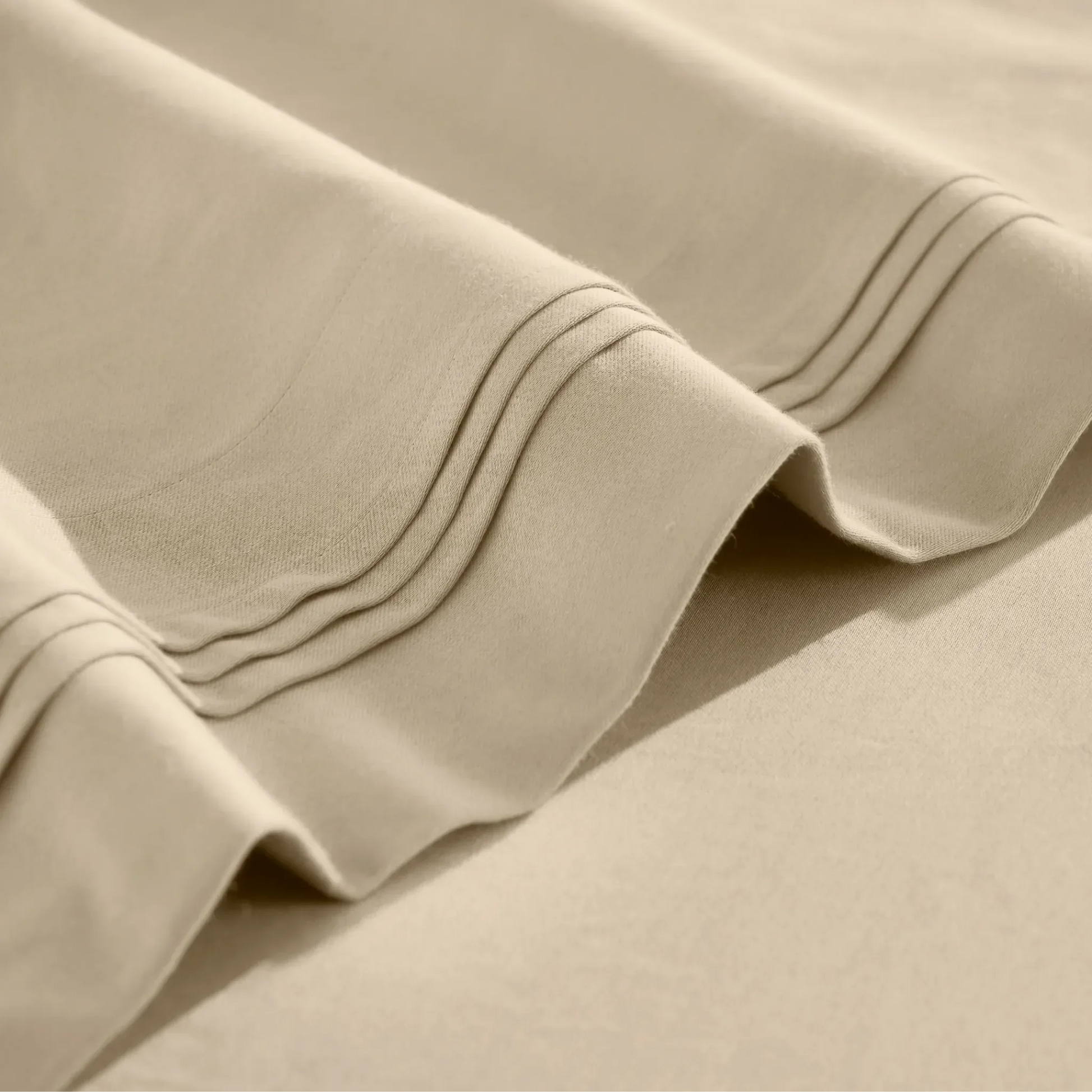 Close-up of Linen Egyptian cotton sateen sheet hems with decorative triple-row stitching.