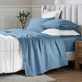 Medium blue Egyptian Cotton Sateen Sheet Set styled on a modern bed with white accents