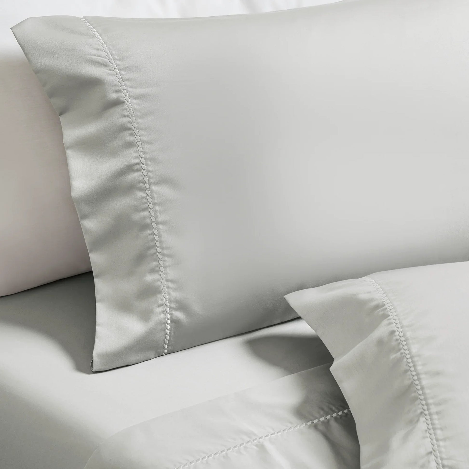Platinum Imperia embroidered hem pillowcase set close-up detail.