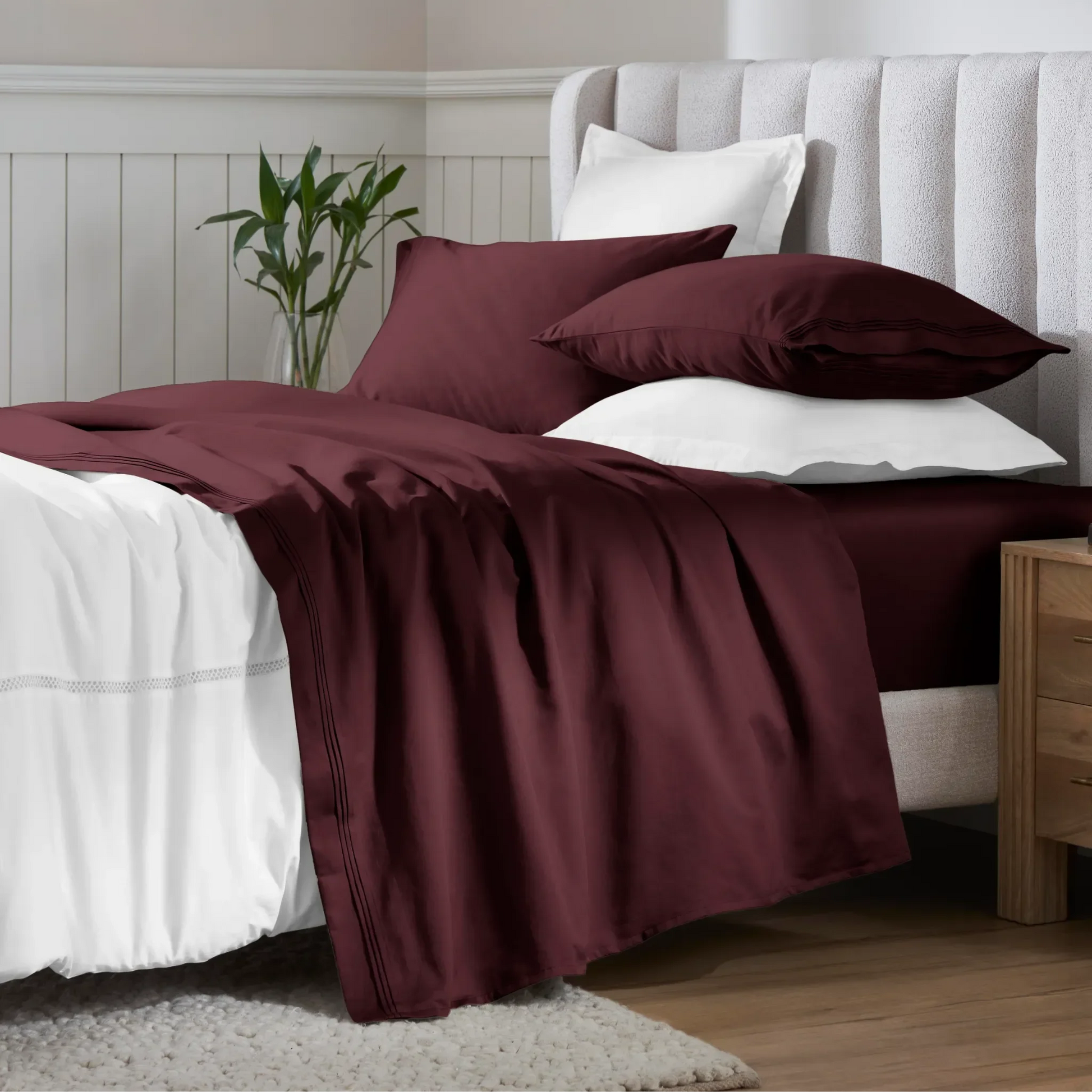 Plum Red Egyptian Cotton Sateen Sheet Set styled on a modern bed with white accents