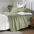 Sage green Egyptian Cotton Sateen Sheet Set styled on a modern bed with white accents