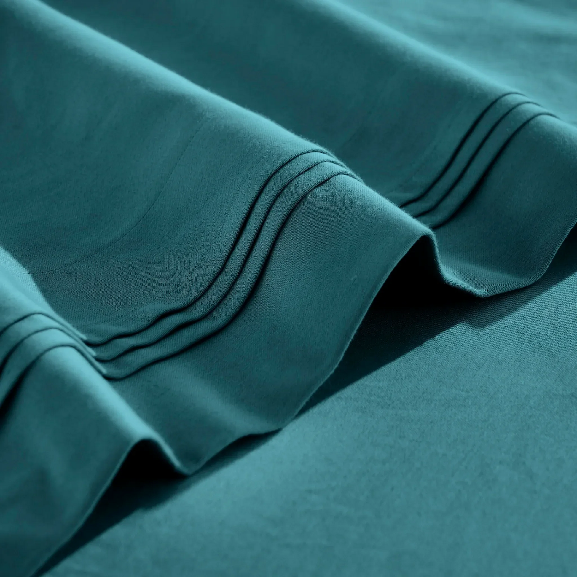 Stitched embroidery detail on Caribbean blue Egyptian Cotton Sateen sheets