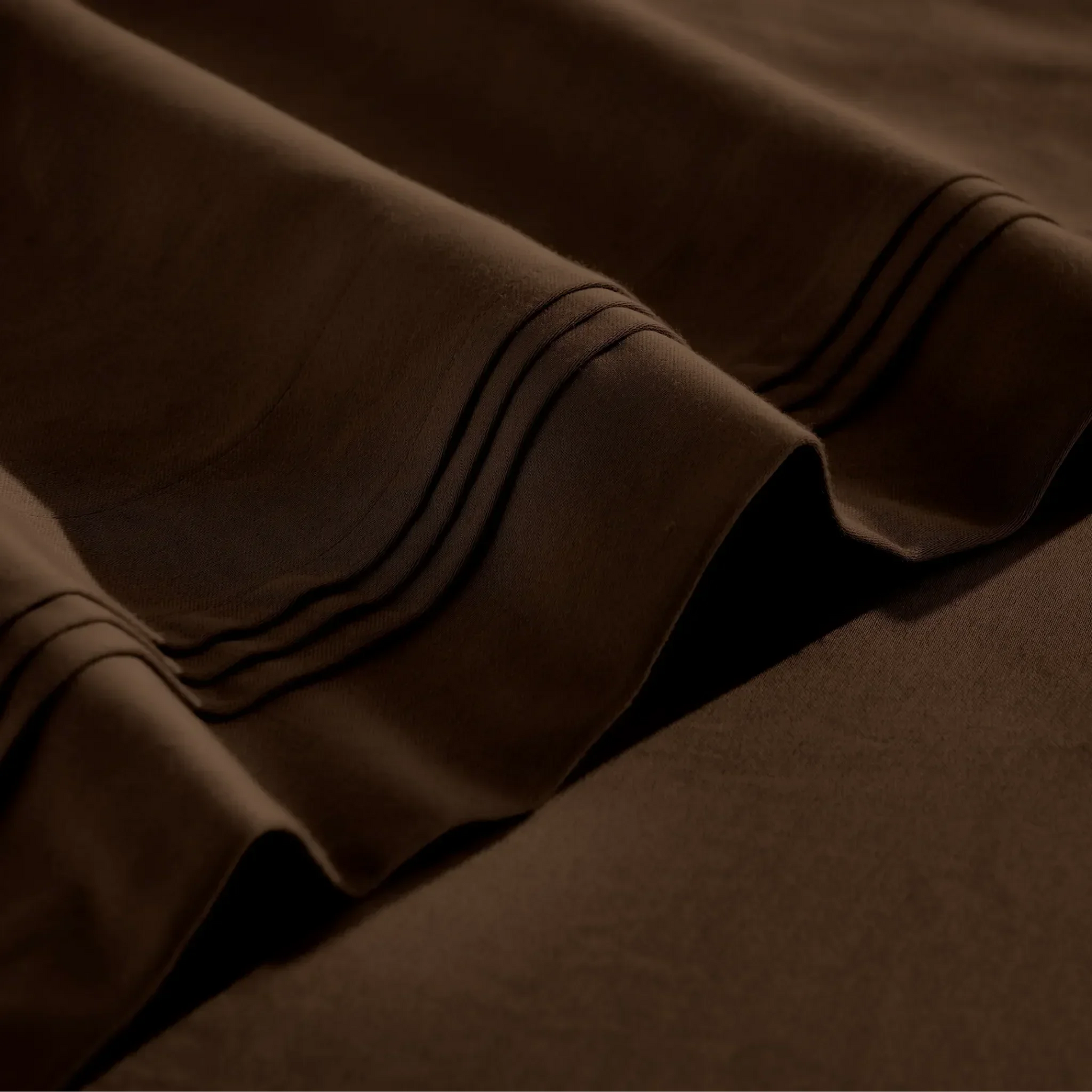 Stitched embroidery detail on chocolate brown Egyptian Cotton Sateen sheets