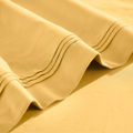 Stitched embroidery detail on gold yellow Egyptian Cotton Sateen sheets