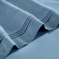 Stitched embroidery detail on medium blue Egyptian Cotton Sateen sheets