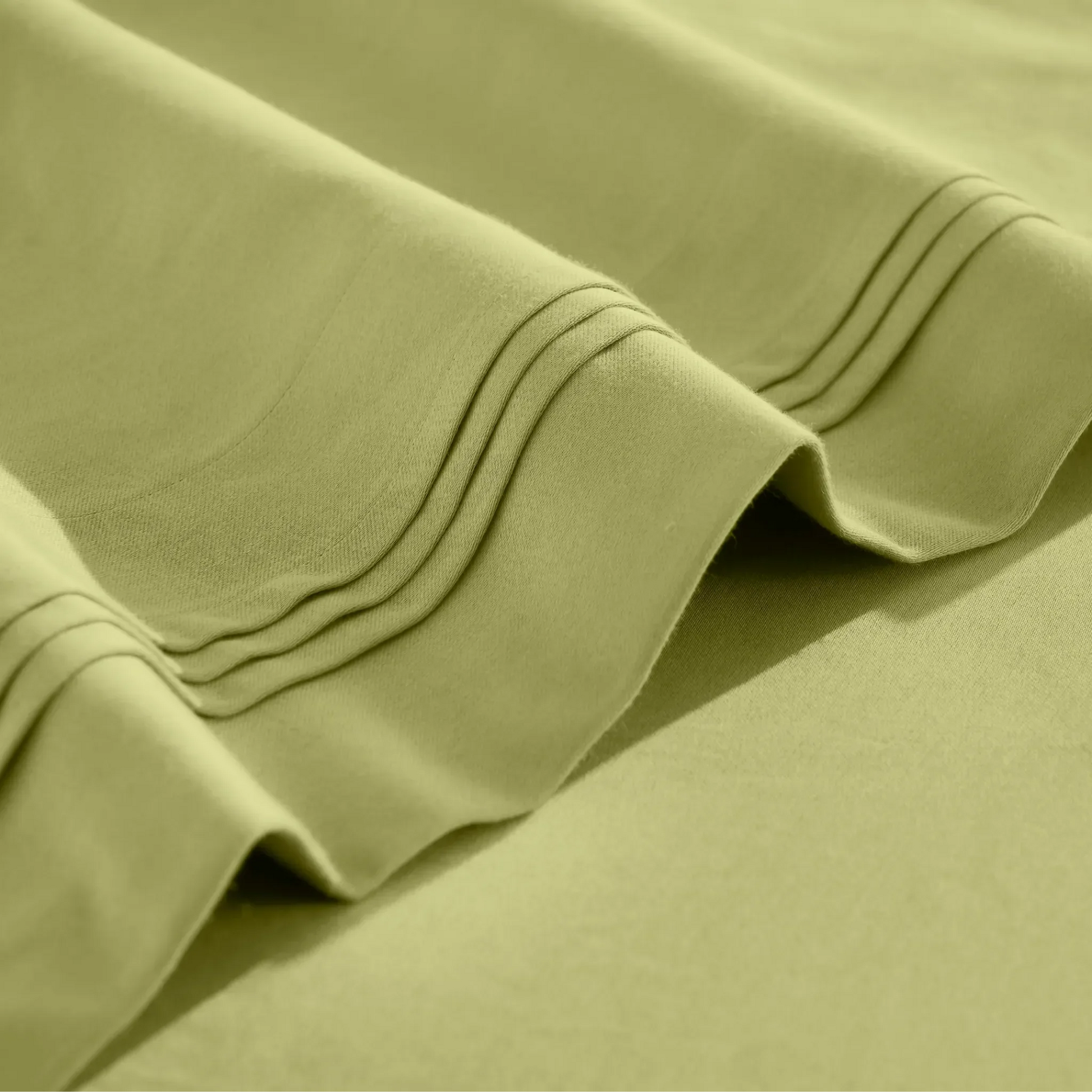 Stitched embroidery detail on olive green Egyptian Cotton Sateen sheets