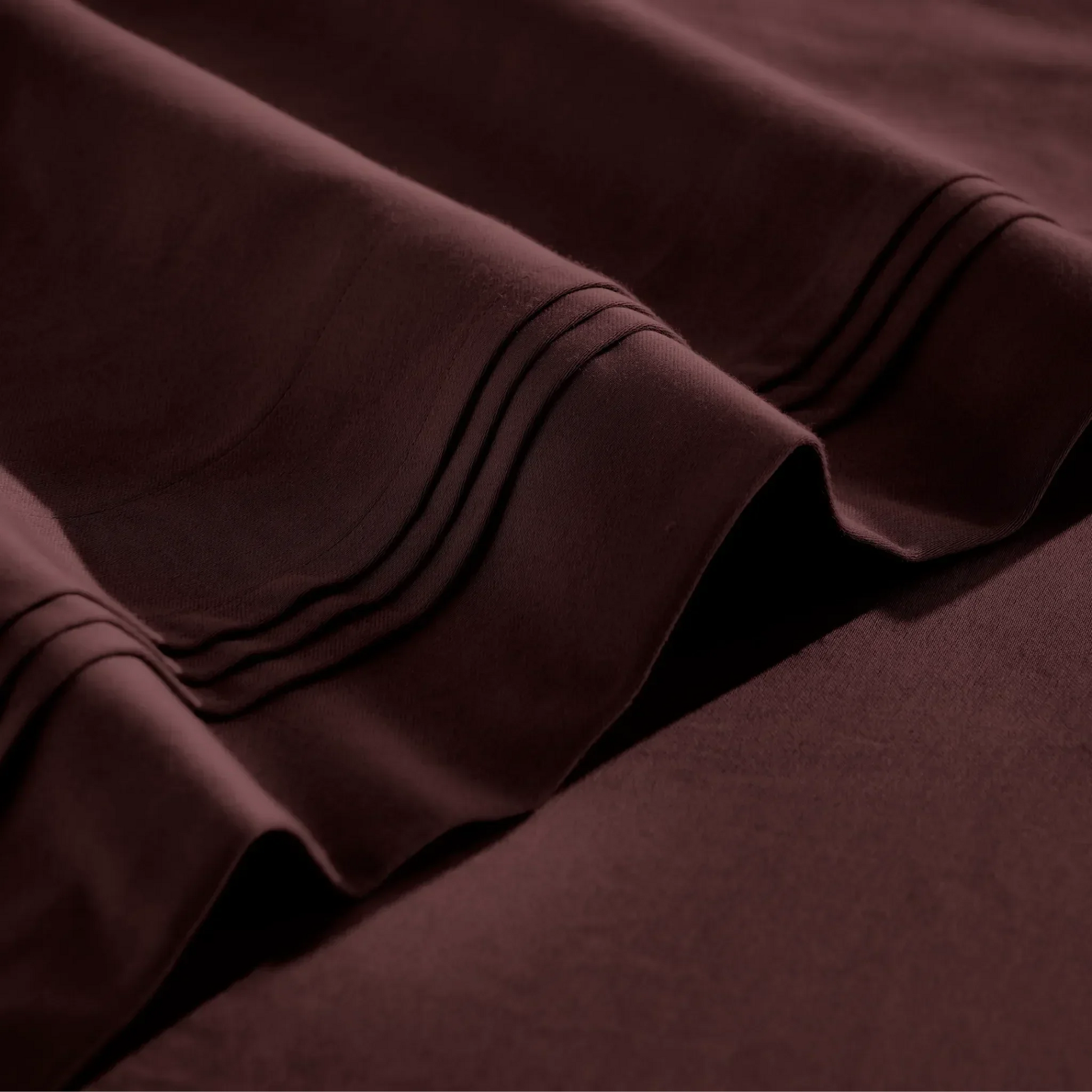 Stitched embroidery detail on plum red Egyptian Cotton Sateen sheets
