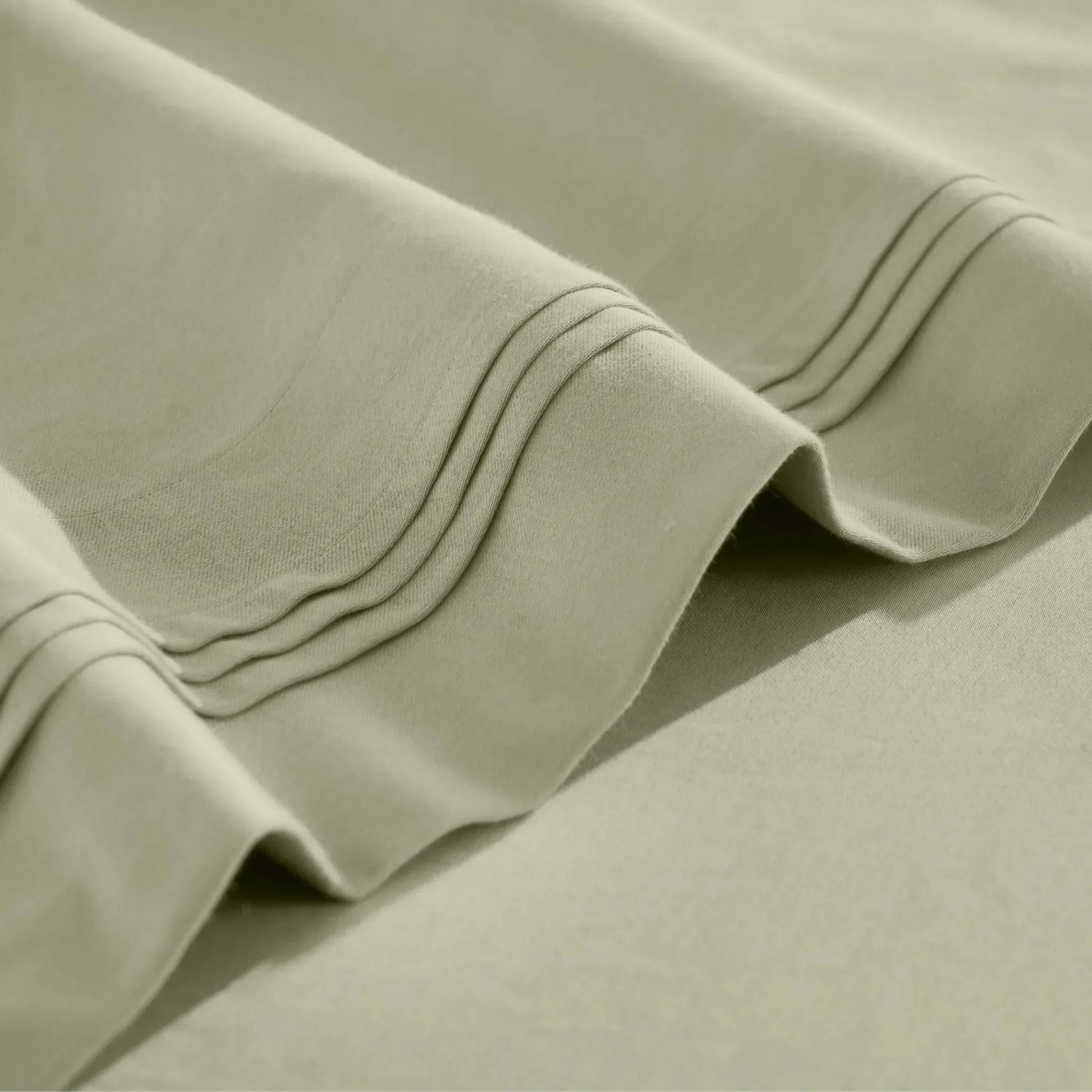 Stitched embroidery detail on sage green Egyptian Cotton Sateen sheets