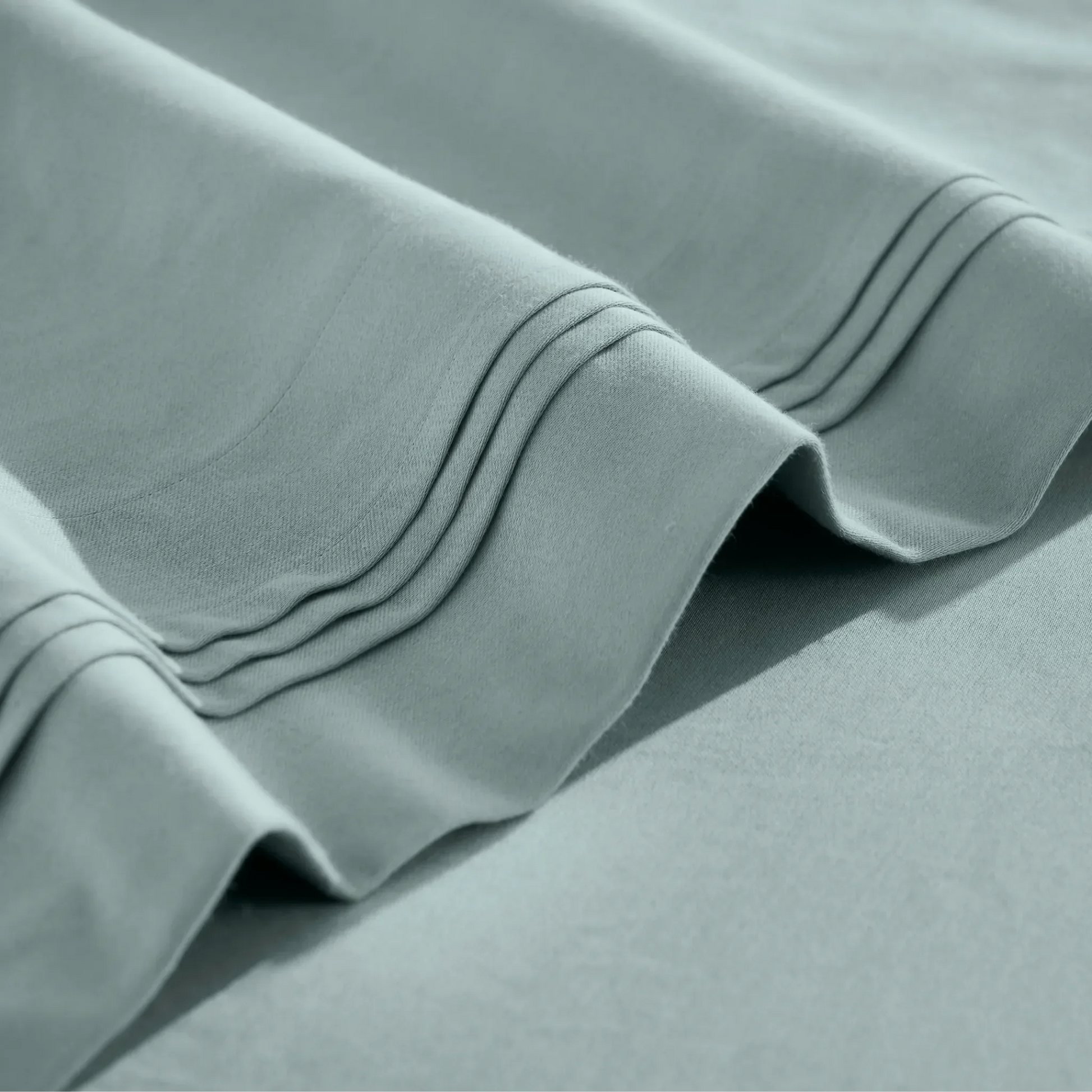 Stitched embroidery detail on teal blue Egyptian Cotton Sateen sheets