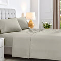 Stone gray 600 thread count cotton blend bed sheet set neatly spread across a mattress.
