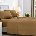 Taupe brown 600 thread count cotton blend bed sheet set neatly spread across a mattress