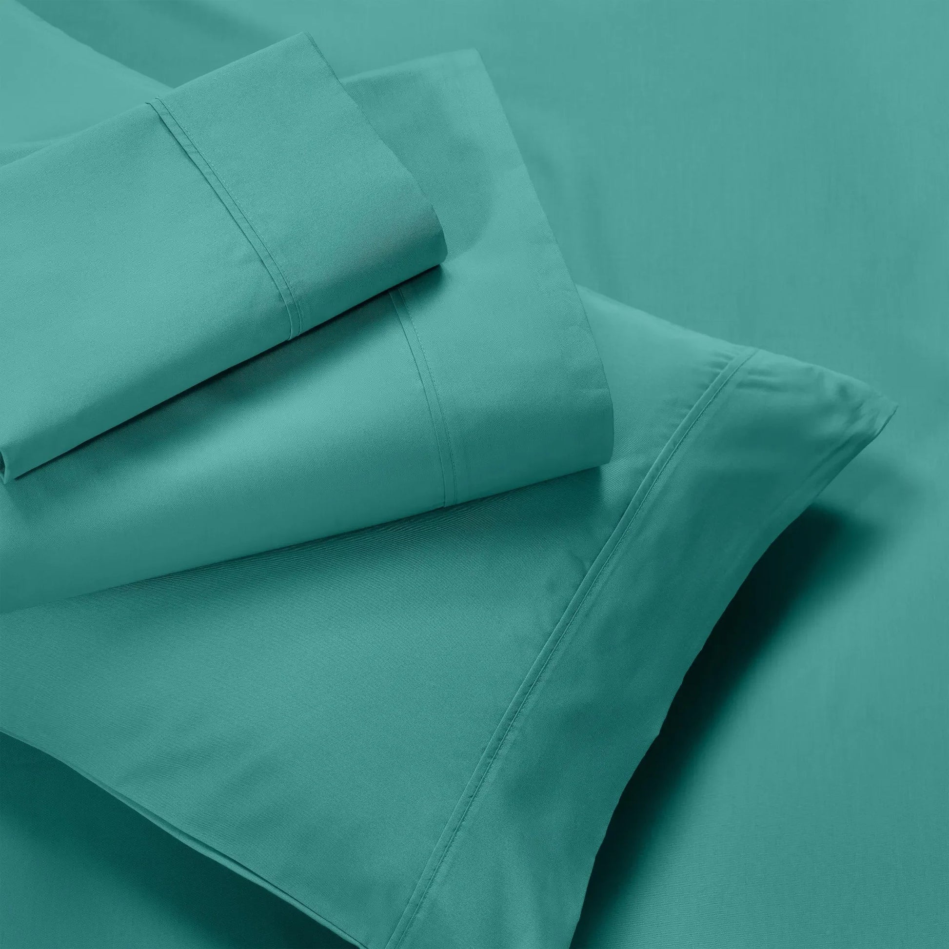 Teal 600 thread count deep pocket sheet set pieces neatly folded and displayed together