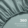 Close-up of an Teal blue fitted sheet with 360-degree elastic for a secure fit around the mattress.